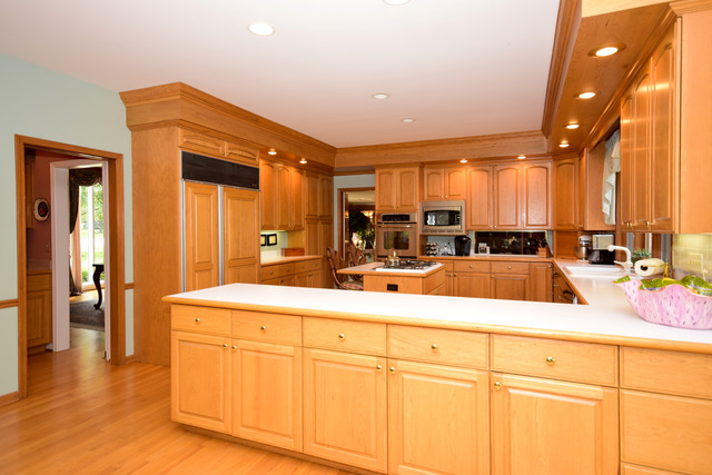 316 Trinity Lane Oak Brook, IL 60523 - Photo 9 of 25 a view of a kitchen with kitchen island granite countertop a sink and cabinets