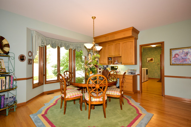 316 Trinity Lane Oak Brook, IL 60523 - Photo 10 of 25 a view of a dining room with furniture window and wooden floor
