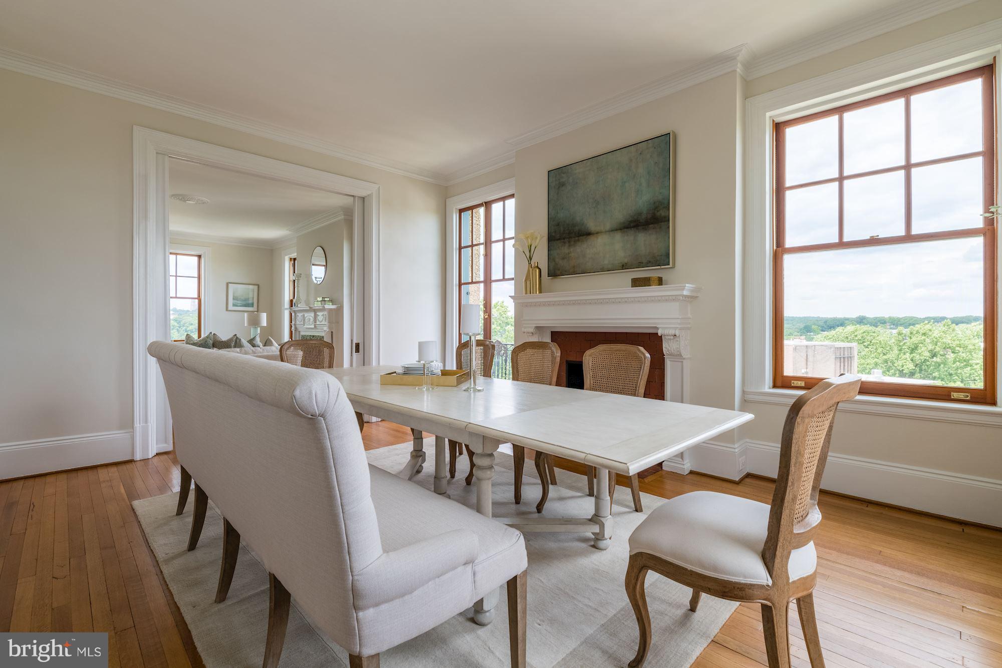 2853 Ontario Road Northwest, Unit 505 Washington, DC 20009 - Photo 14 of 29 a dining room with furniture a fireplace and wooden floor