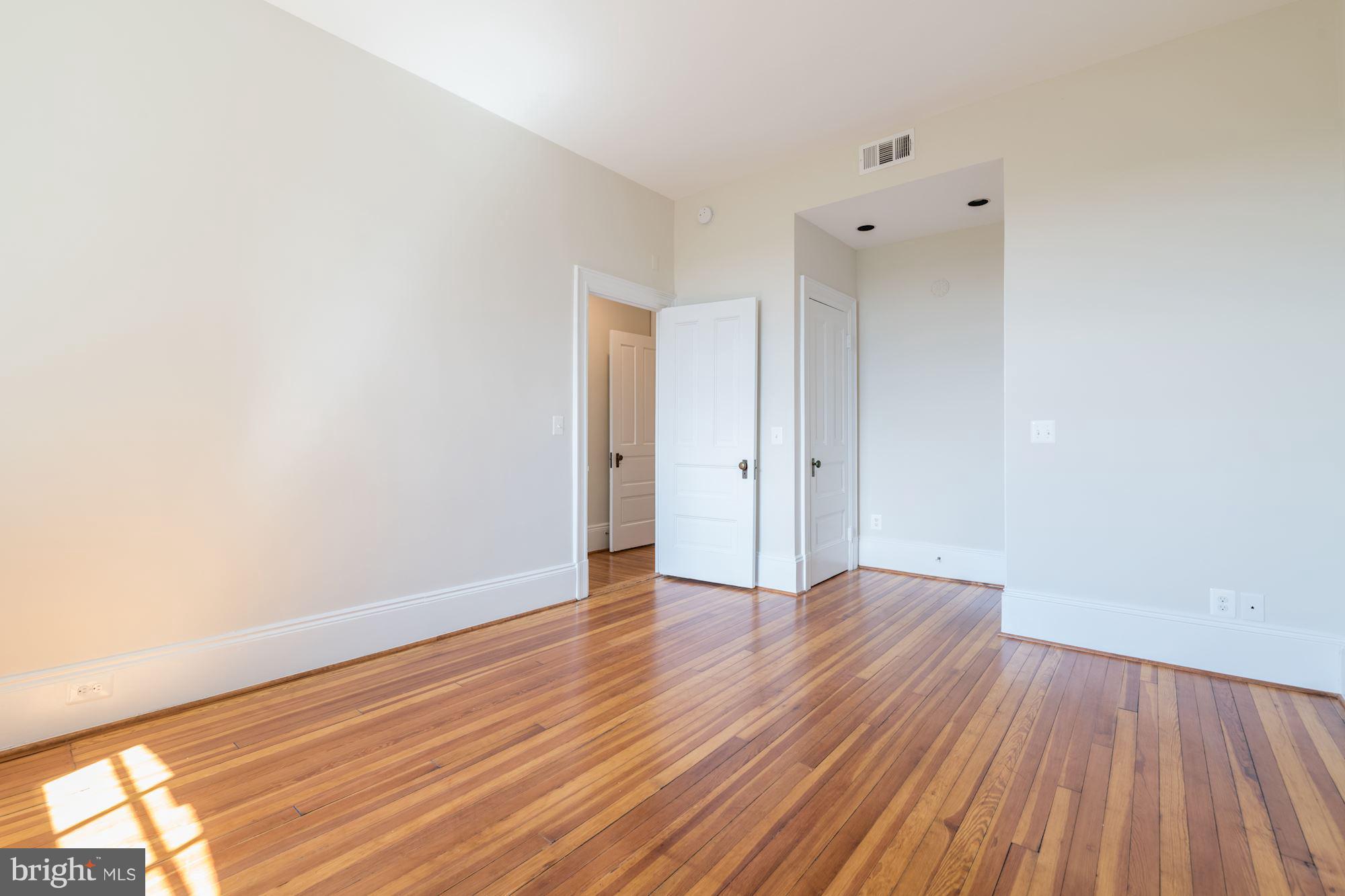 2853 Ontario Road Northwest, Unit 505 Washington, DC 20009 - Photo 18 of 29 a view of an empty room with wooden floor