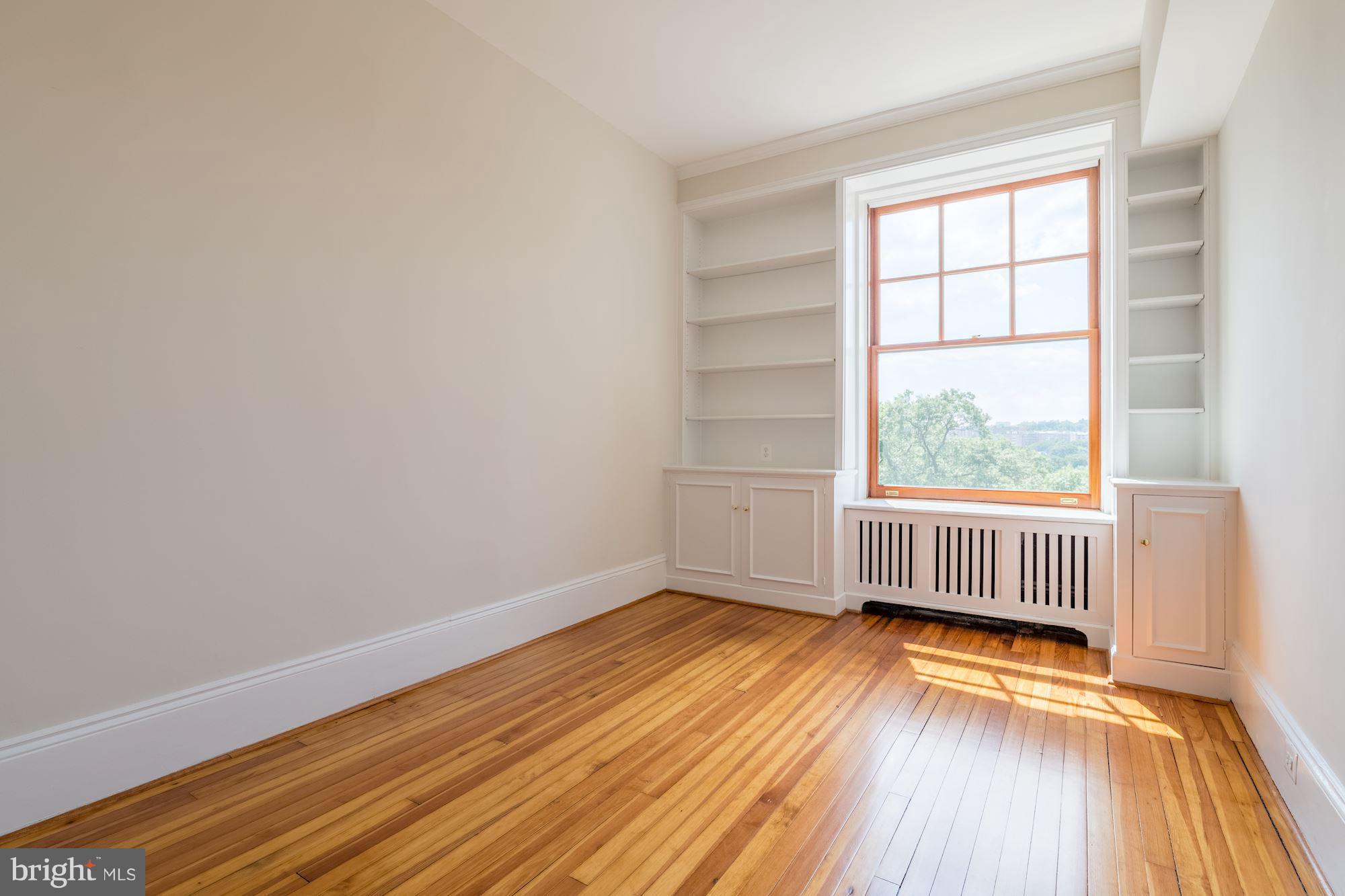 2853 Ontario Road Northwest, Unit 505 Washington, DC 20009 - Photo 25 of 29 an empty room with wooden floor and windows