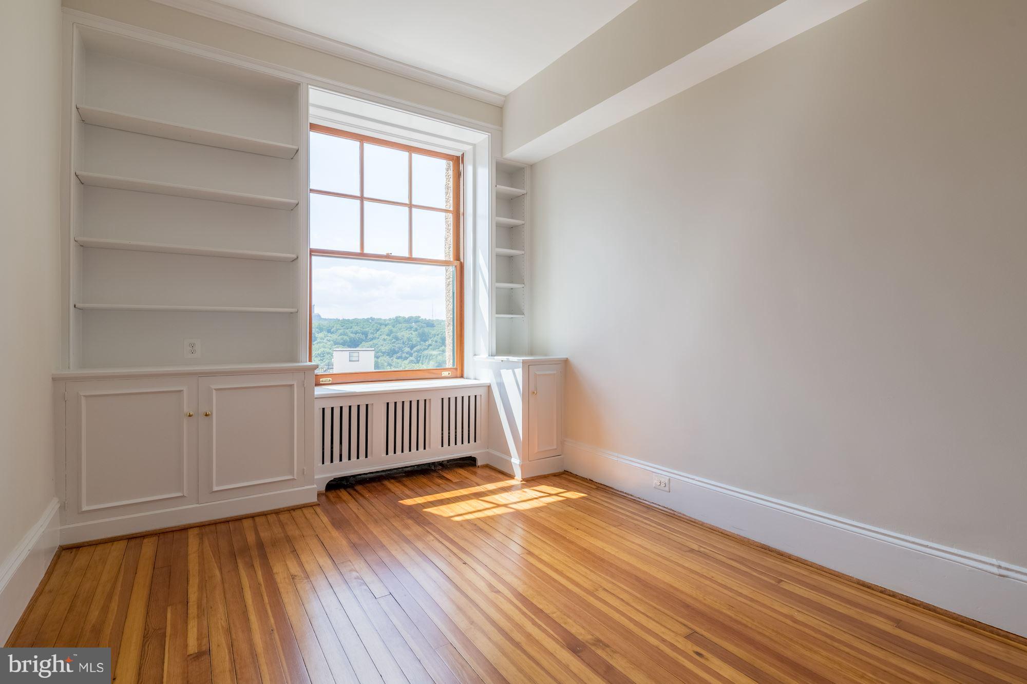 2853 Ontario Road Northwest, Unit 505 Washington, DC 20009 - Photo 26 of 29 an empty room with wooden floor and windows