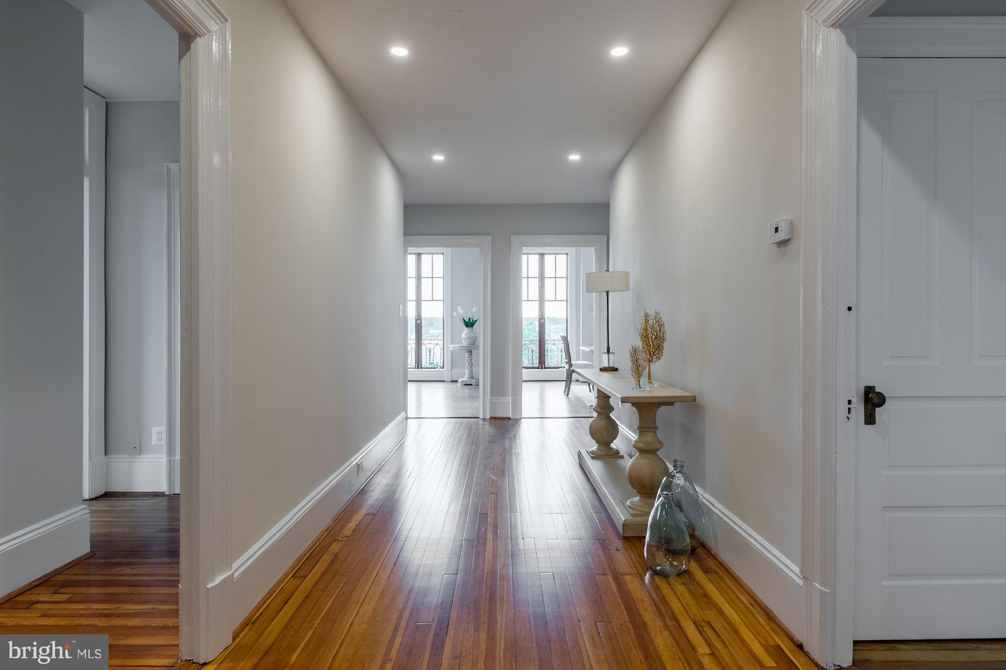 2853 Ontario Road Northwest, Unit 505 Washington, DC 20009 - Photo 4 of 29 a view of a hallway with wooden floor and staircase