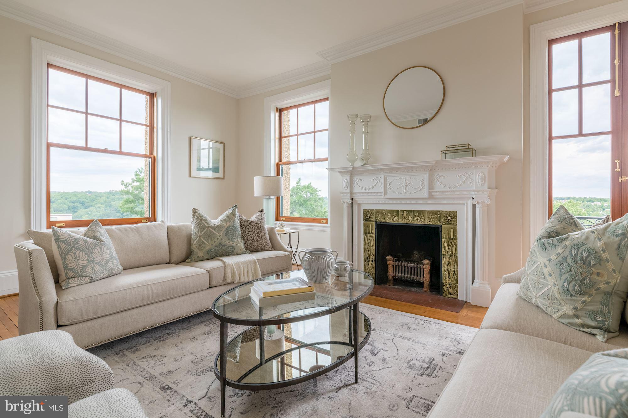 2853 Ontario Road Northwest, Unit 505 Washington, DC 20009 - Photo 6 of 29 a living room with furniture a window and a fireplace