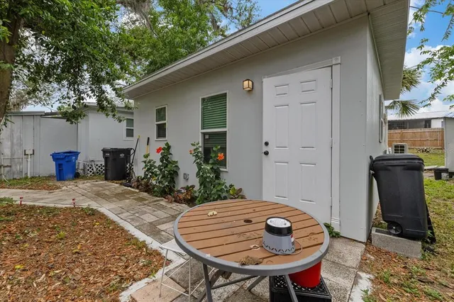 a backyard of a house with table and chairs