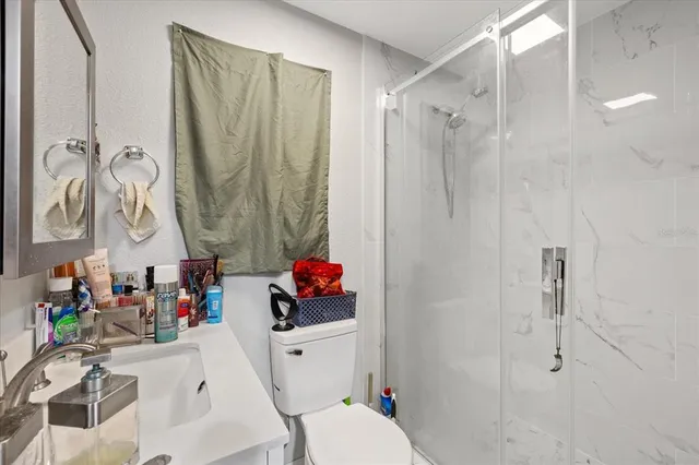 a bathroom with a sink toilet and shower