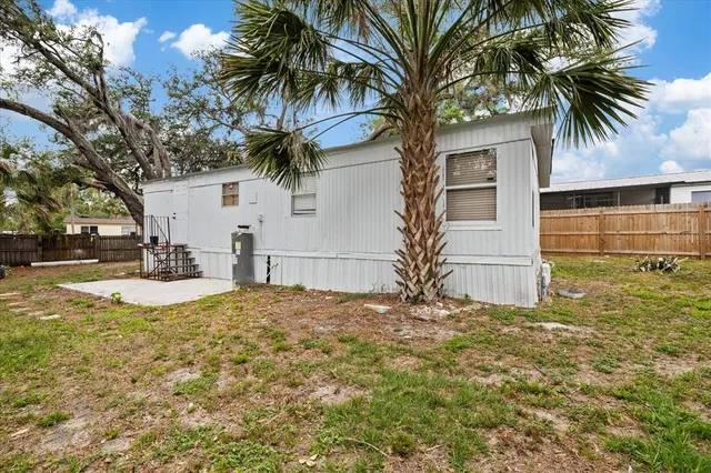 a view of a yard with snow on the tree