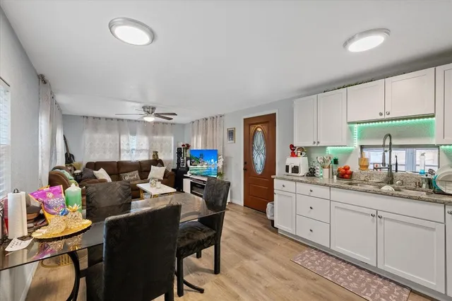 a living room with furniture and a kitchen