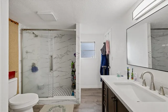 a bathroom with a sink toilet and shower