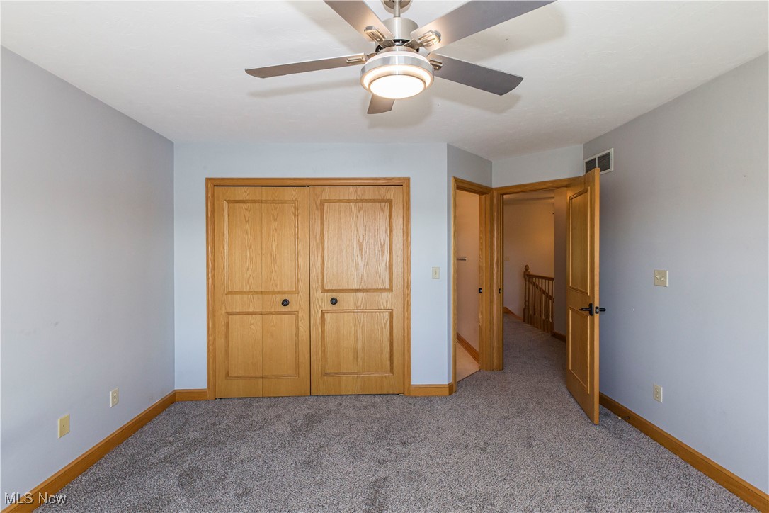1570 Reimer Road Wadsworth, OH 44281 - Photo 29 of 48 Third bedroom with carpet, a closet, a ceiling fan, and a bathroom entrance