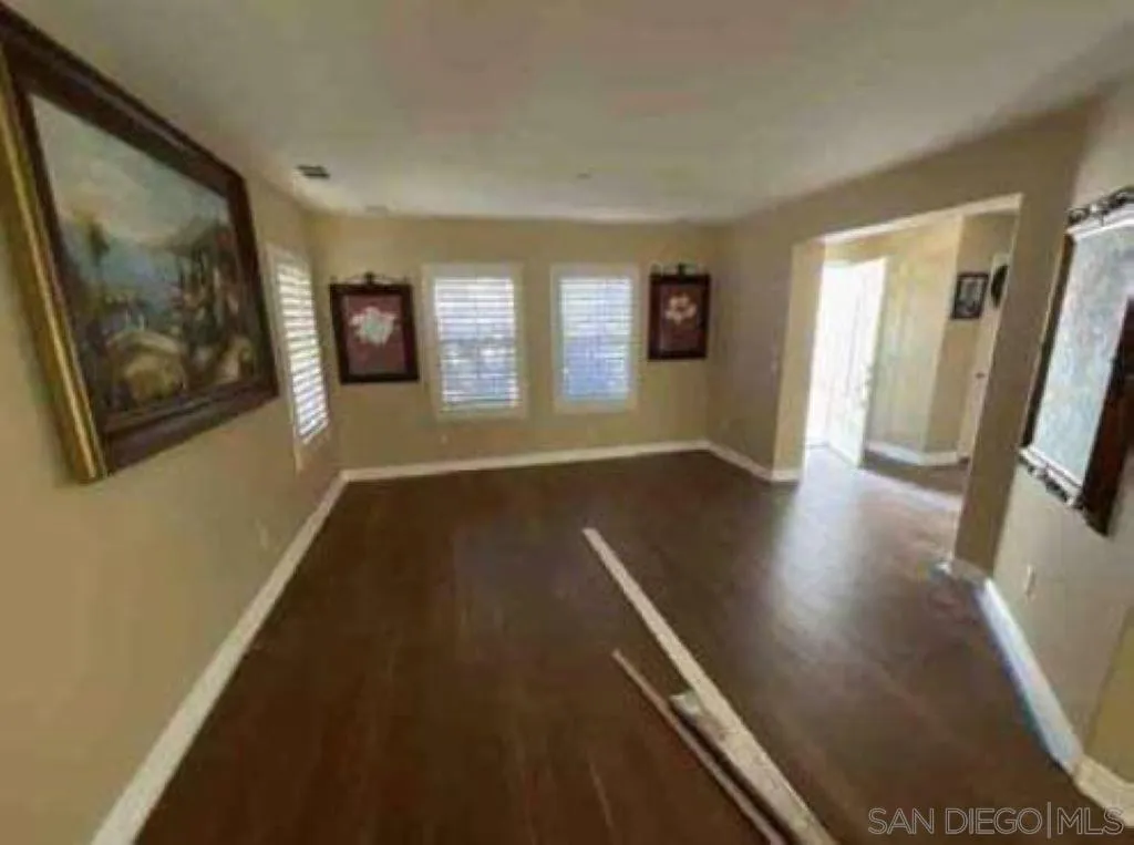 2552 Valley Waters Court Spring Valley, CA 91978 - Photo 11 of 16 a view of an empty room with wooden floor and a window