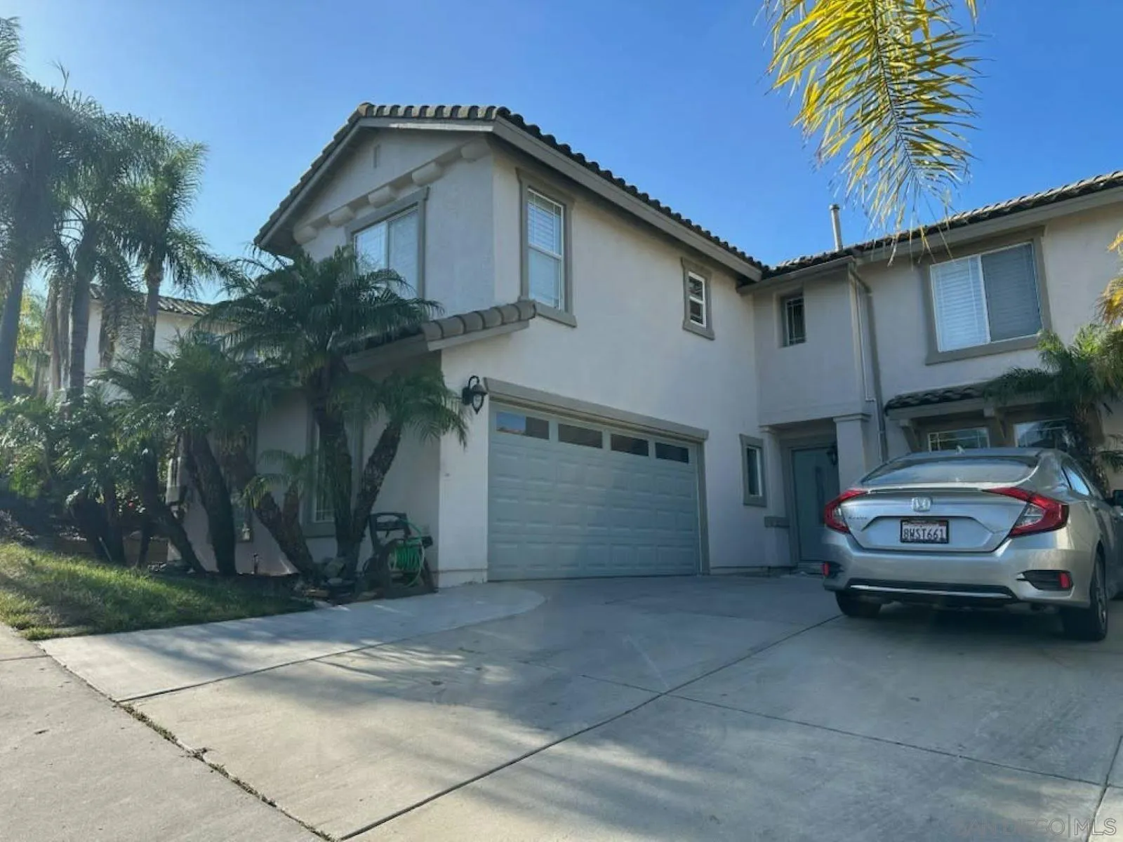 2552 Valley Waters Court Spring Valley, CA 91978 - Photo 2 of 16 a car parked in front of white house