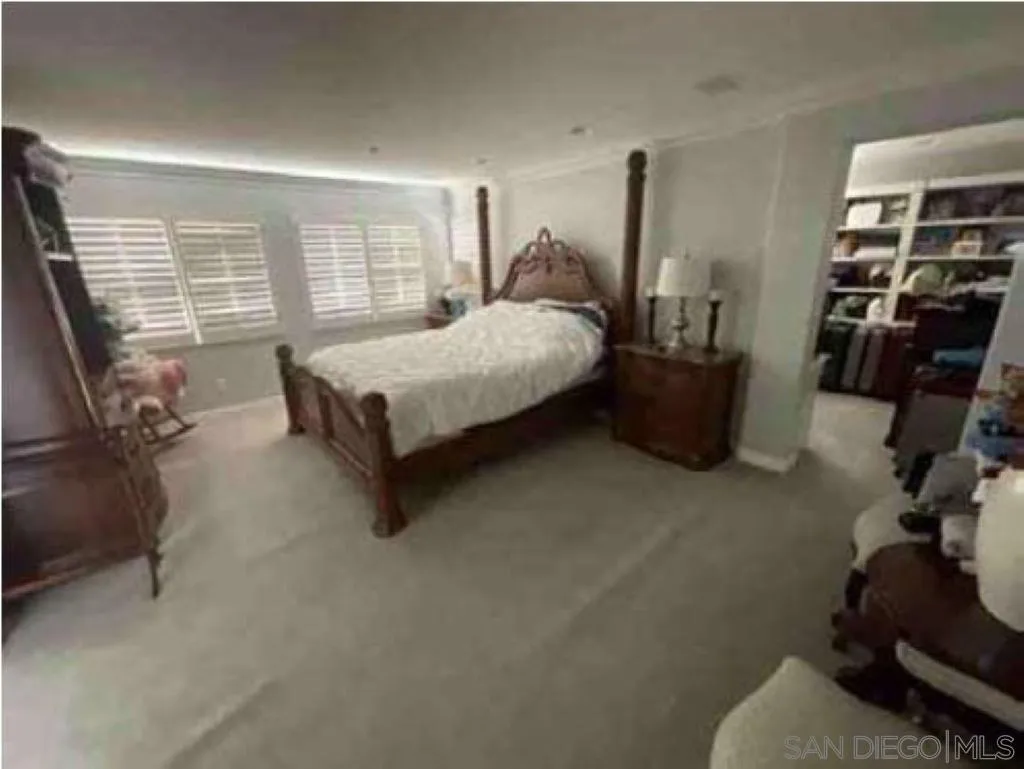 2552 Valley Waters Court Spring Valley, CA 91978 - Photo 7 of 16 a large bed sitting in a room next to a window