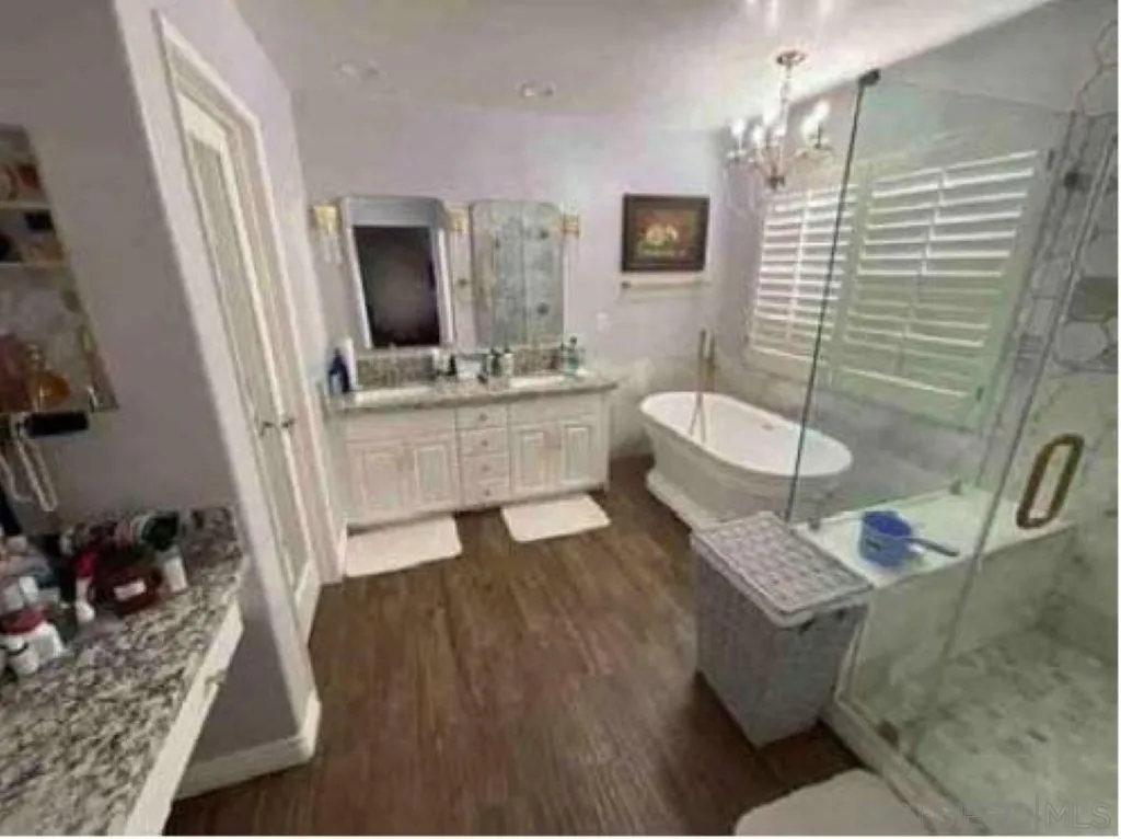 2552 Valley Waters Court Spring Valley, CA 91978 - Photo 8 of 16 a bathroom with a tub sink and mirror