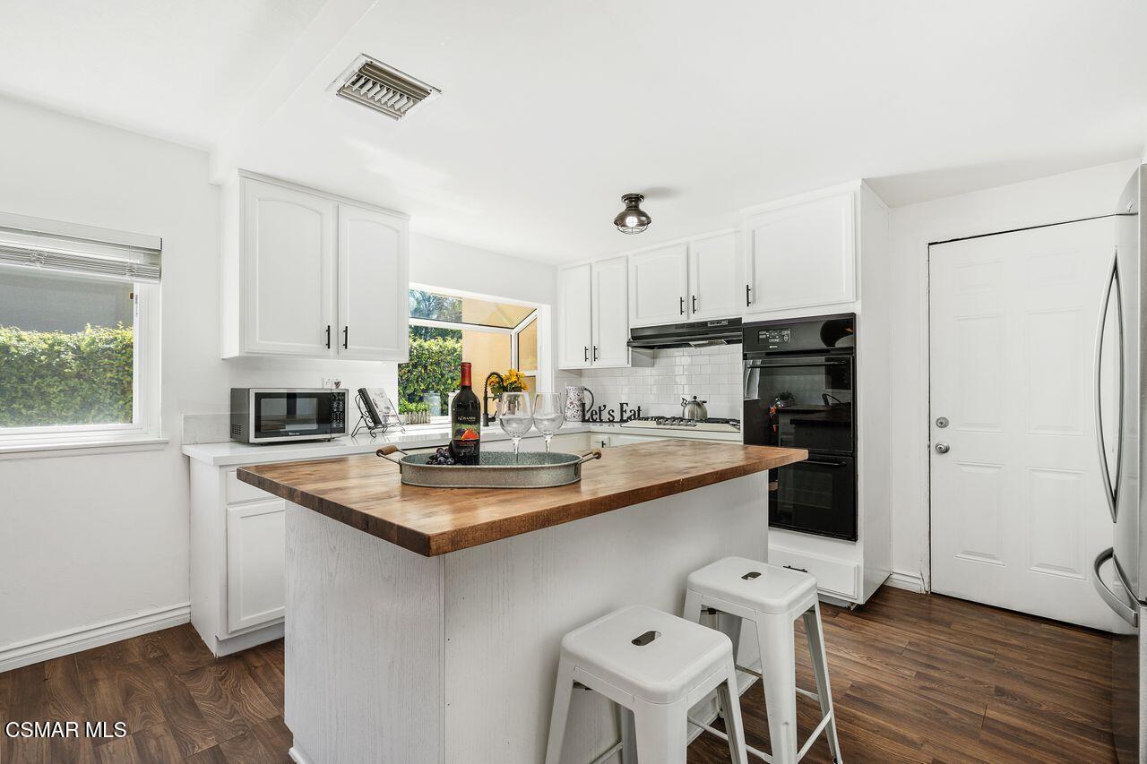 2142 Atwater Avenue Simi Valley, CA 93063 - Photo 13 of 36 a kitchen with stainless steel appliances granite countertop a sink stove and refrigerator