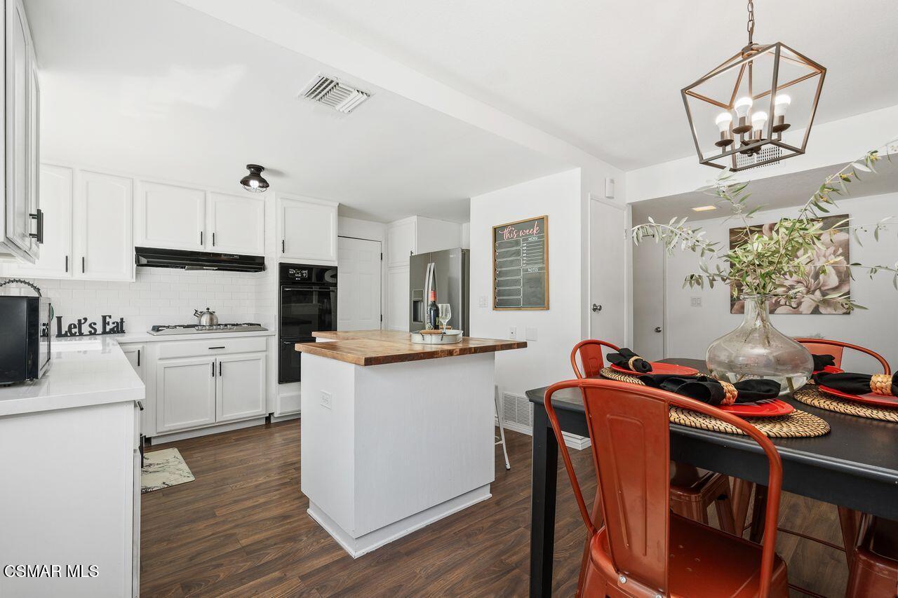 2142 Atwater Avenue Simi Valley, CA 93063 - Photo 14 of 36 a kitchen that has a lot of cabinets a sink and appliances in it