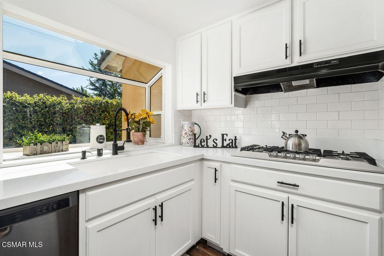 2142 Atwater Avenue Simi Valley, CA 93063 - Photo 16 of 36 a kitchen with stainless steel appliances granite countertop a sink a stove and cabinets