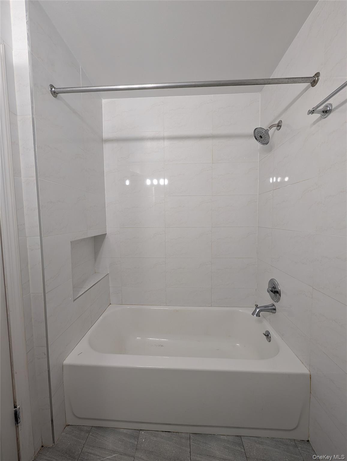 43-04 158th Street, Unit L4 Queens, NY 11358 - Photo 12 of 21 Full bath with tile patterned floors, shower / bath combination, and tile walls