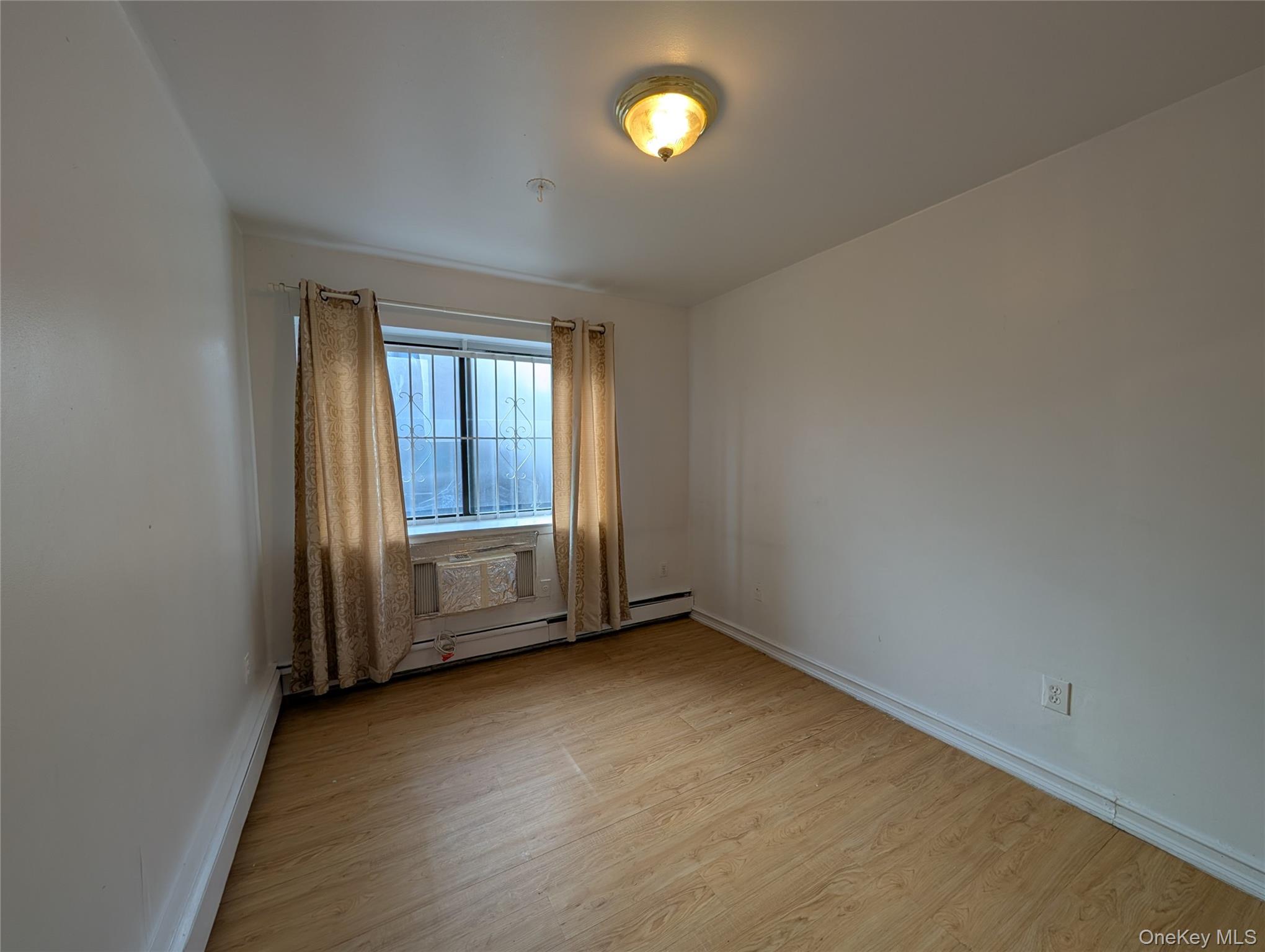 43-04 158th Street, Unit L4 Queens, NY 11358 - Photo 13 of 21 Unfurnished room with light wood-type flooring and baseboards