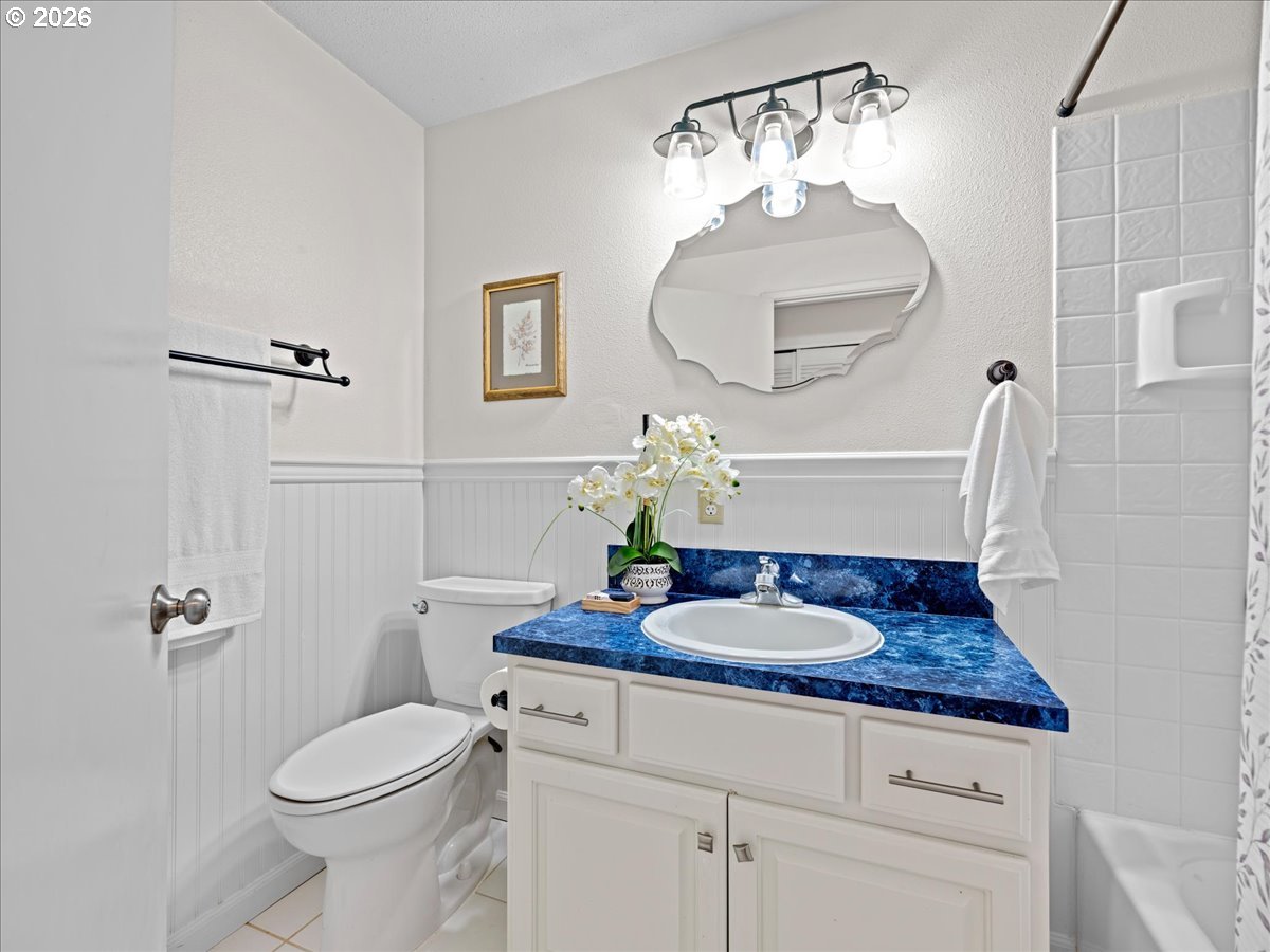 3775 3rd Avenue North Keizer, OR 97303 - Photo 19 of 32 a bathroom with a granite countertop sink a toilet and mirror