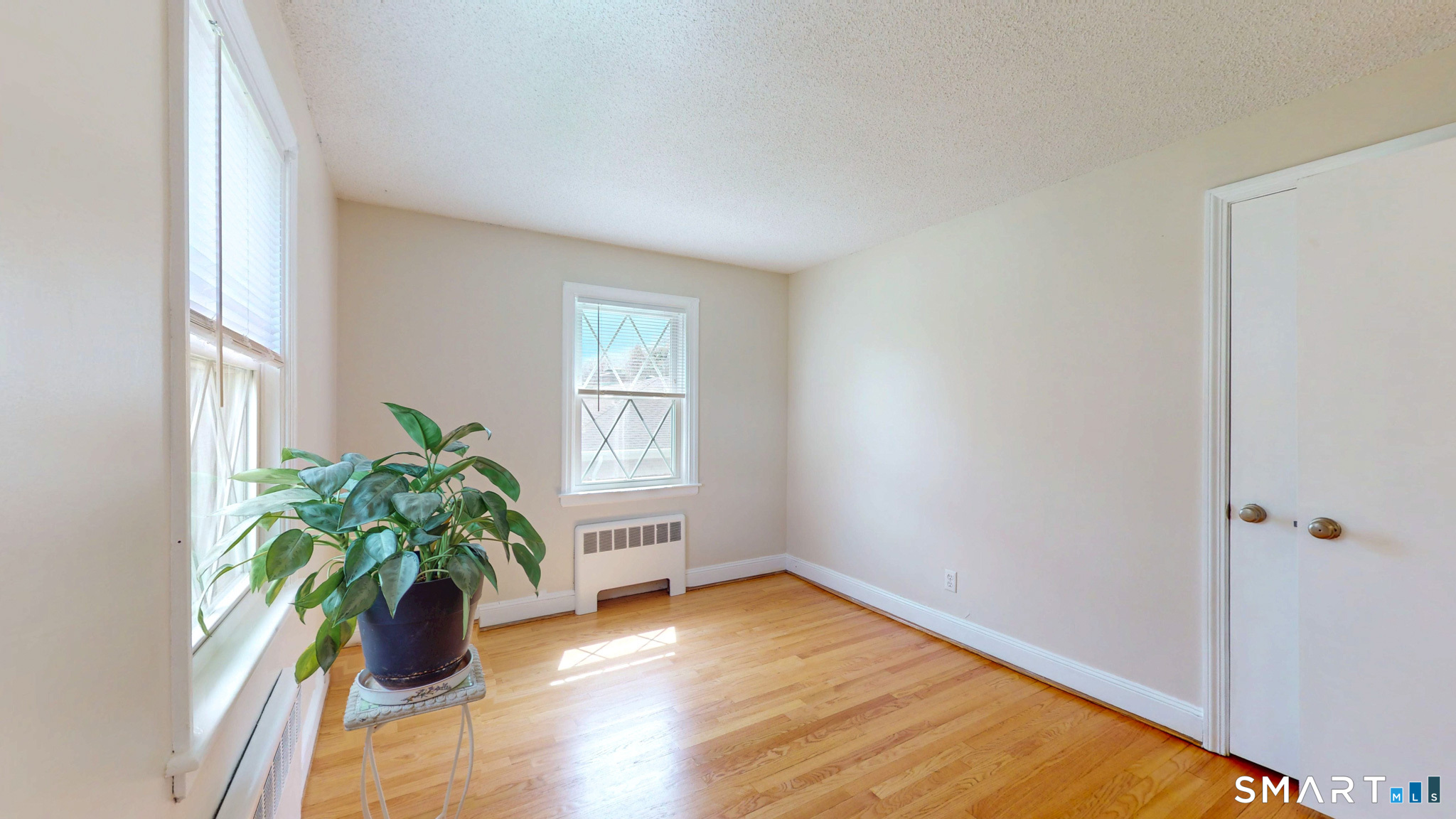 99 Sunset Ridge Drive East Hartford, CT 06118 - Photo 17 of 39 wooden floor in an empty room with a window