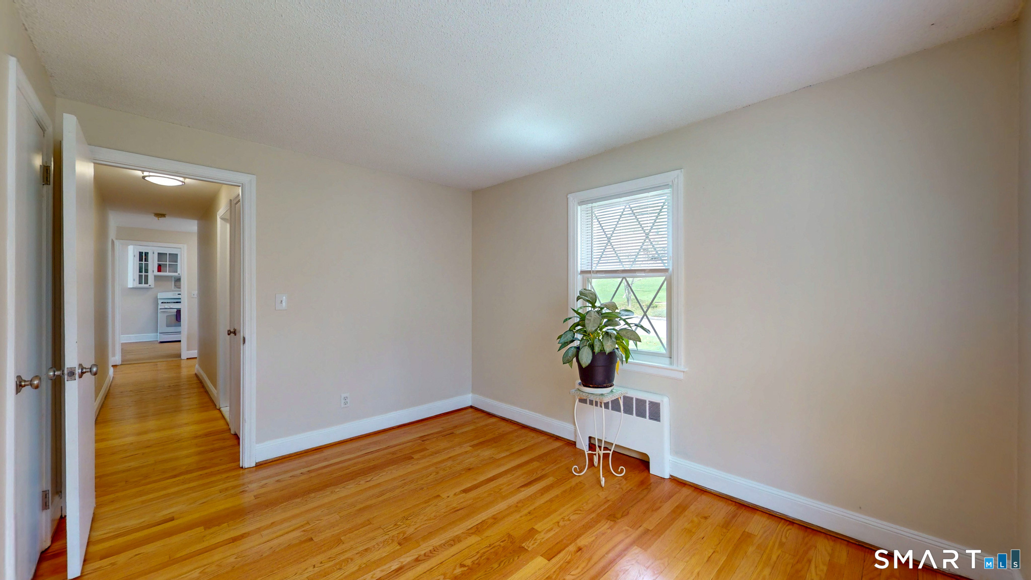 99 Sunset Ridge Drive East Hartford, CT 06118 - Photo 20 of 39 a view of an empty room with wooden floor and a window