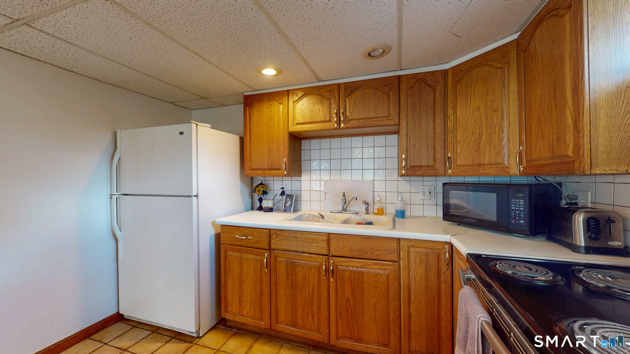 99 Sunset Ridge Drive East Hartford, CT 06118 - Photo 27 of 39 a kitchen with stainless steel appliances a refrigerator sink and cabinets