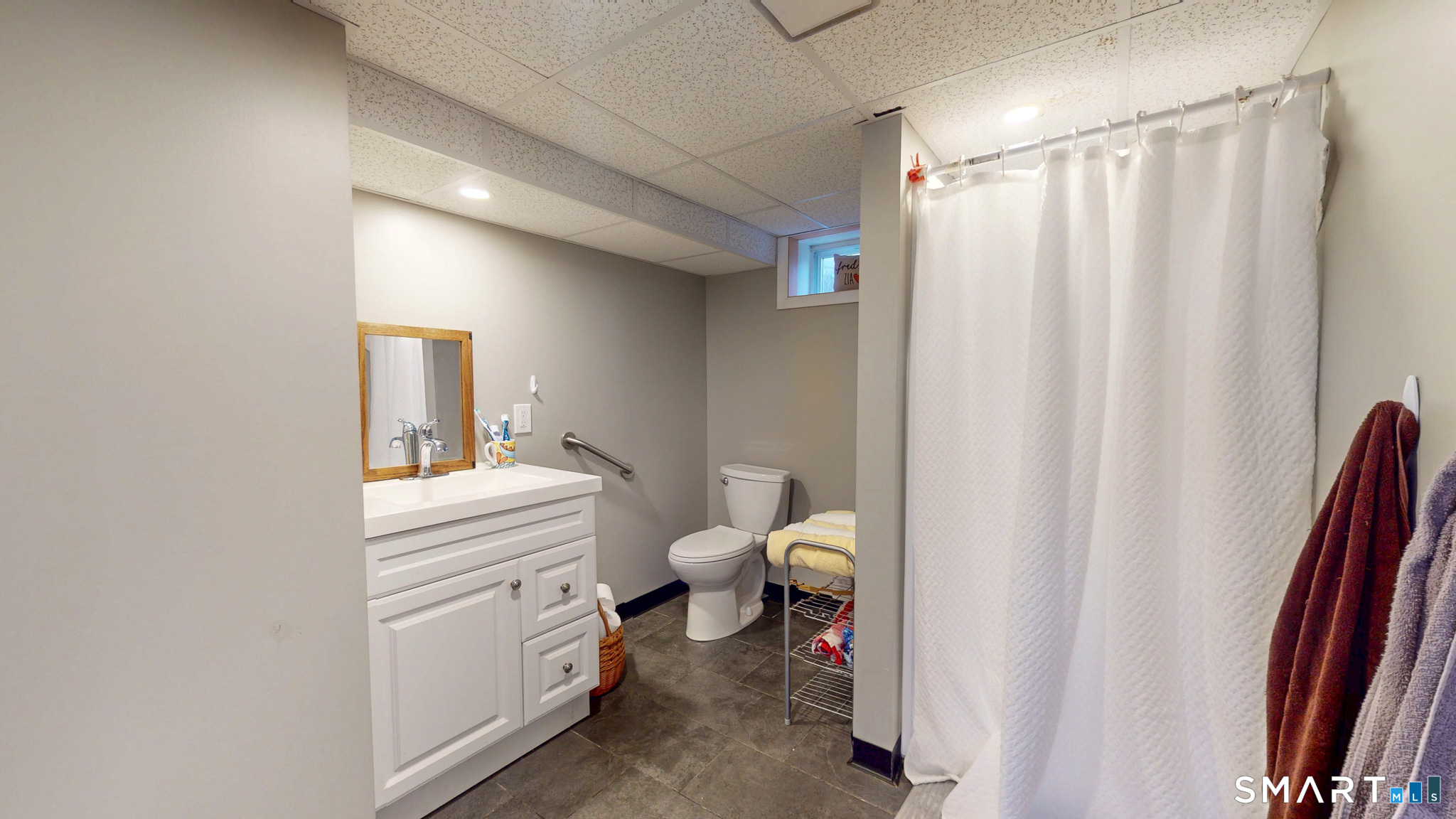 99 Sunset Ridge Drive East Hartford, CT 06118 - Photo 33 of 39 a bathroom with a sink a toilet and shower curtain