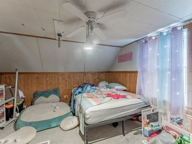 a bedroom with a bed a chandelier and closet