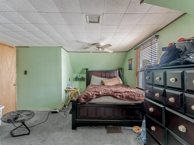 a bedroom with a bed and a tv