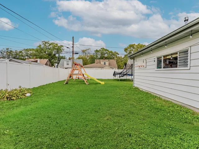 a view of a backyard with plants and a garden