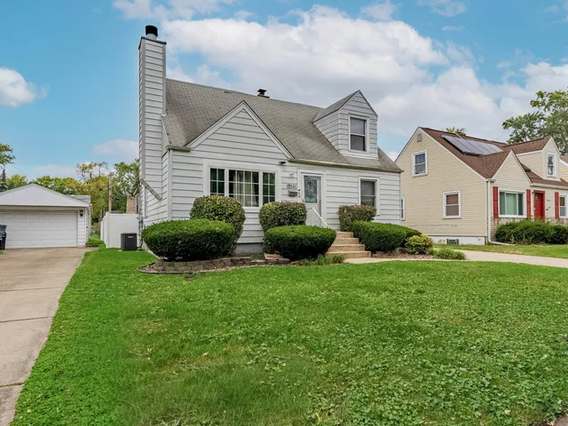 a view of a house with a big yard and potted plants