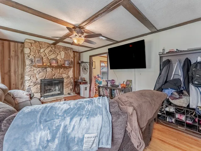 a living room with furniture a flat screen tv and a fireplace