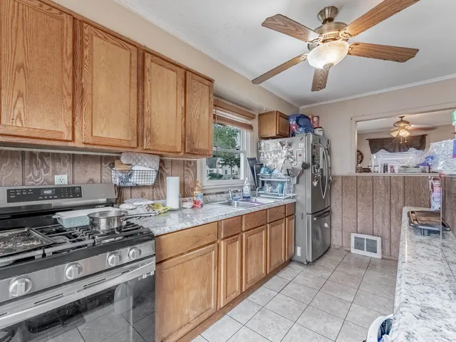a kitchen with stainless steel appliances granite countertop a stove sink and cabinets