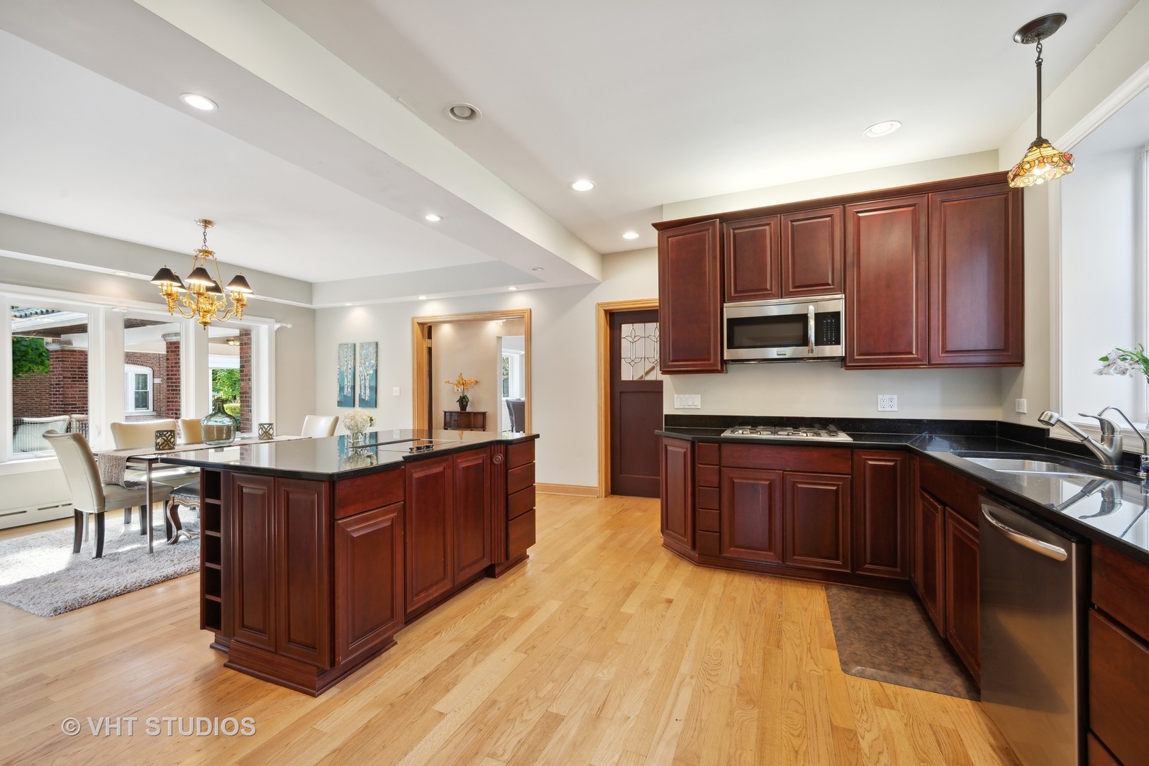 823 Jackson Avenue River Forest, IL 60305 - Photo 11 of 44 a large kitchen with stainless steel appliances granite countertop a stove a sink dishwasher a dining table and chairs with wooden floor