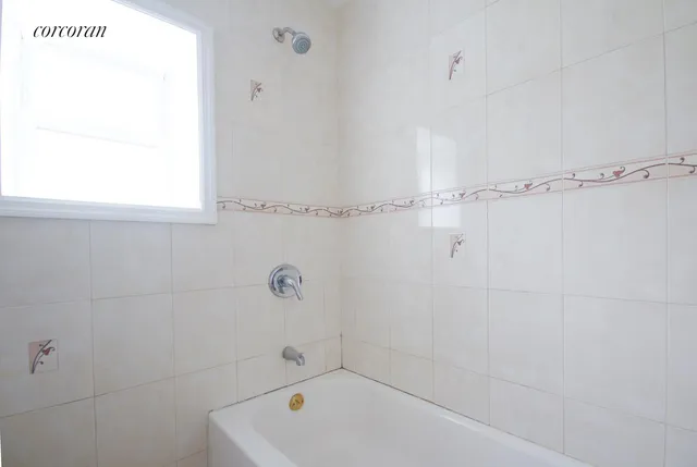 a bathroom with a tub and a shower
