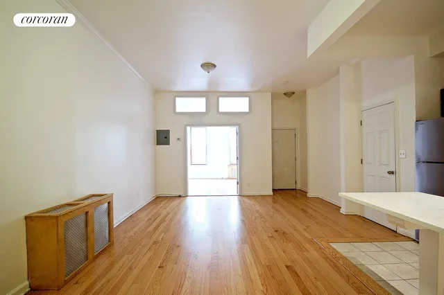 a view of a room with wooden floor and natural light