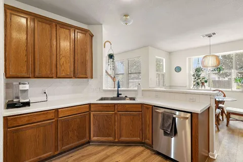a kitchen with a sink cabinets and window