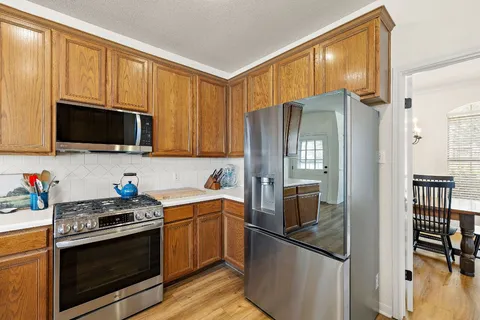 a kitchen with stainless steel appliances a refrigerator stove and microwave