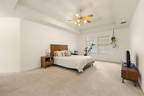 a bedroom with a bed and a chandelier