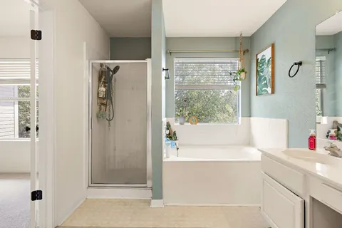 a bathroom with a bathtub and a shower