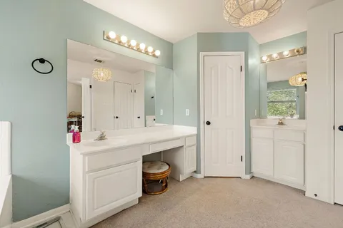a bathroom with a sink vanity and a mirror