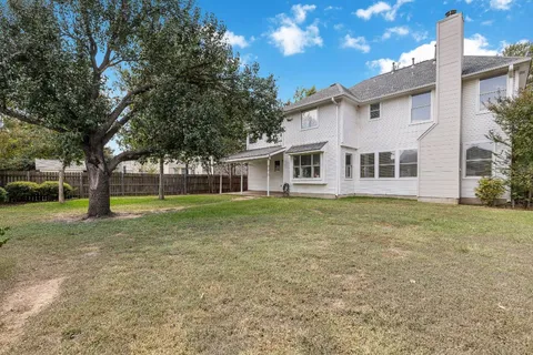 a view of a house with a backyard