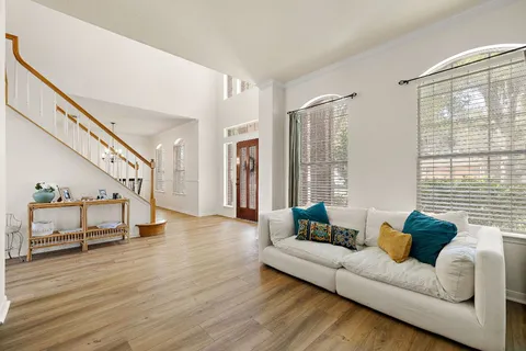 a living room with furniture and wooden floor
