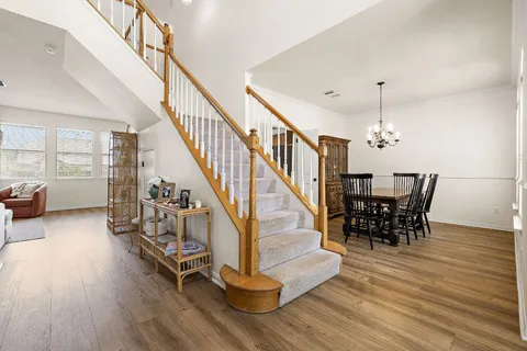 a dining room with furniture entryway and wooden floor