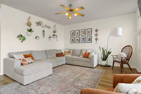 a living room with furniture and wooden floor
