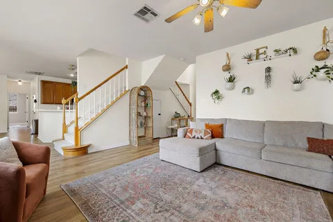 a living room with furniture and wooden floor