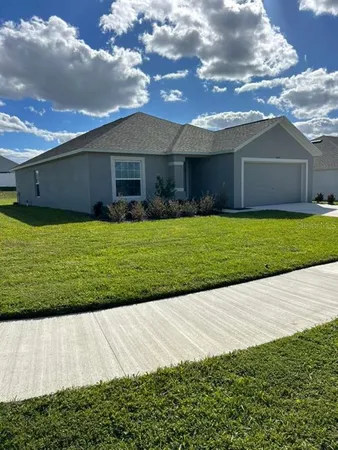 a front view of house with a garden