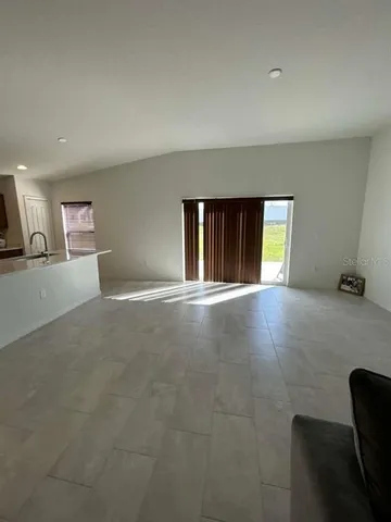 a view of an empty room with a window