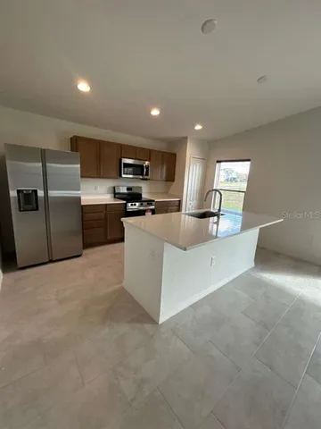 a kitchen with refrigerator and furniture
